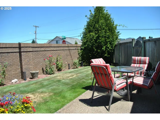 a view of a chairs and table in backyard
