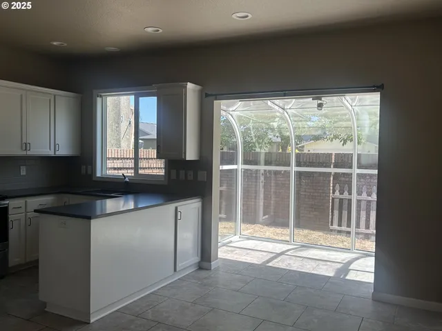 a kitchen with a sink and a large window