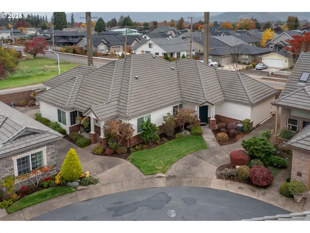 an aerial view of a house with a yard and potted plants