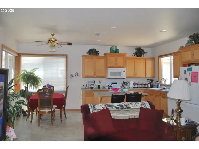 a view of a dining room with furniture and a chandelier