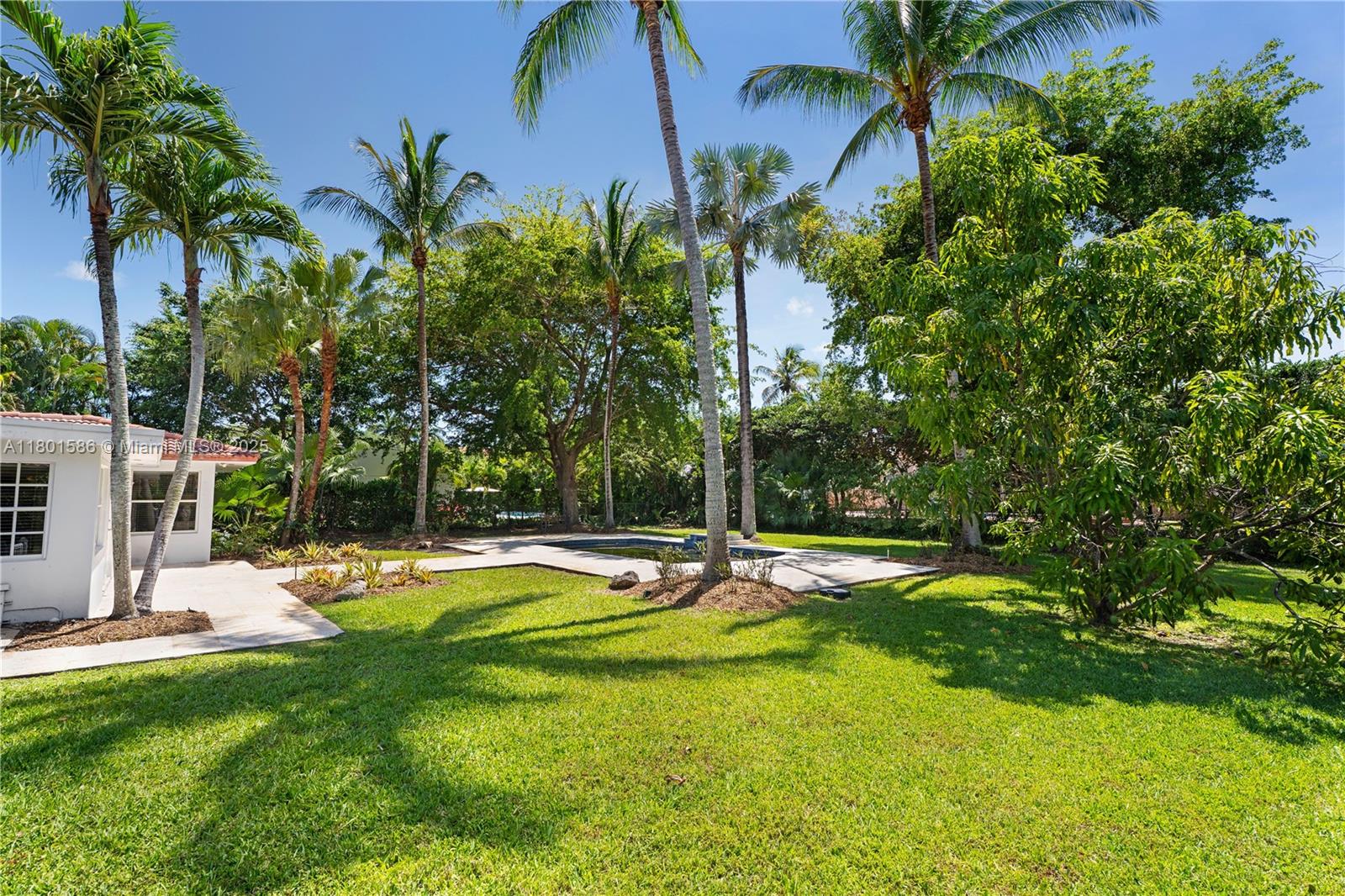 8700 Southwest 64th Avenue Pinecrest, FL 33156 - Photo 2 of 11 a swimming pool with outdoor seating and yard