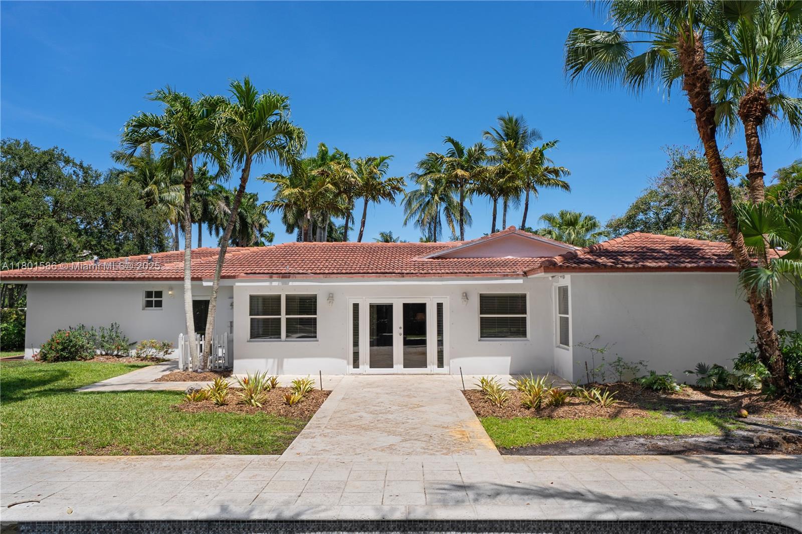 8700 Southwest 64th Avenue Pinecrest, FL 33156 - Photo 9 of 11 a front view of a house with garden