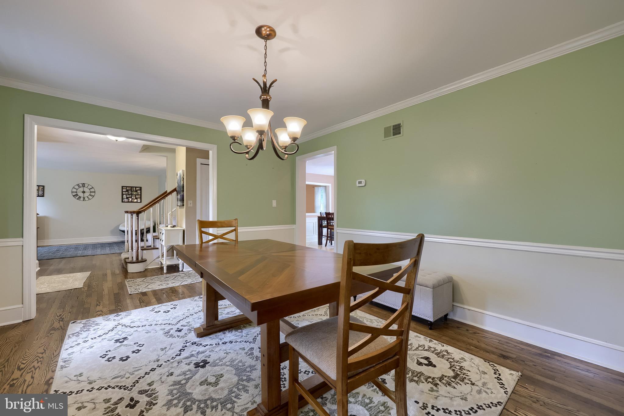 2504 Brookside Drive Lancaster, PA 17601 - Photo 16 of 53 a dining room with wooden floor a chandelier a wooden table and chairs