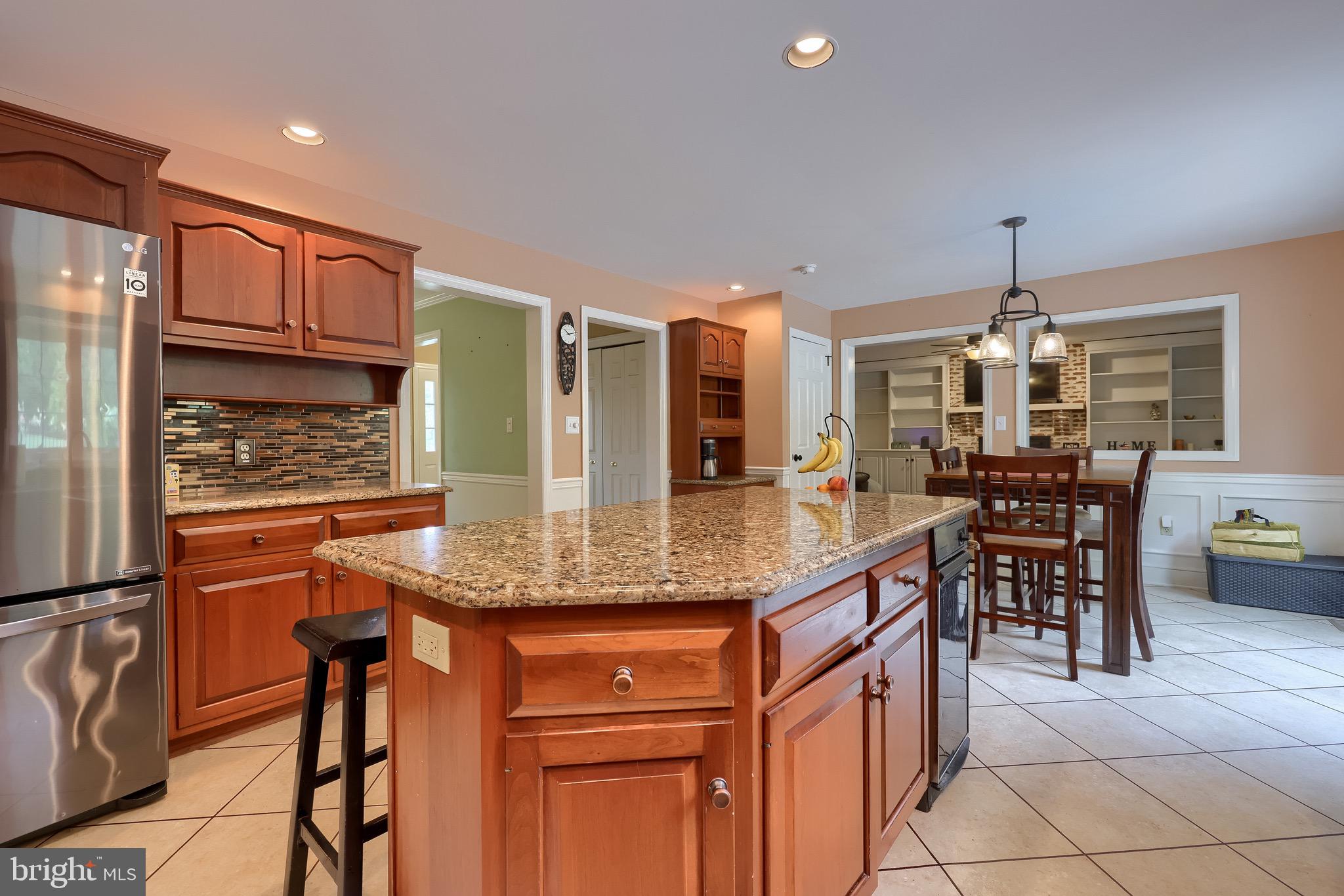 2504 Brookside Drive Lancaster, PA 17601 - Photo 19 of 53 a kitchen with stainless steel appliances granite countertop table chairs and granite counter tops