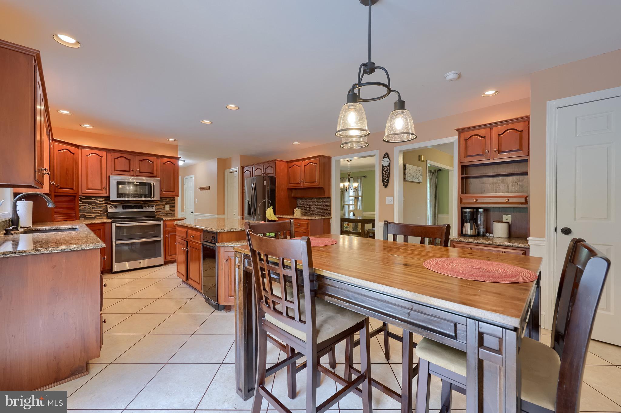 2504 Brookside Drive Lancaster, PA 17601 - Photo 25 of 53 a kitchen with stainless steel appliances granite countertop table chairs stove and refrigerator