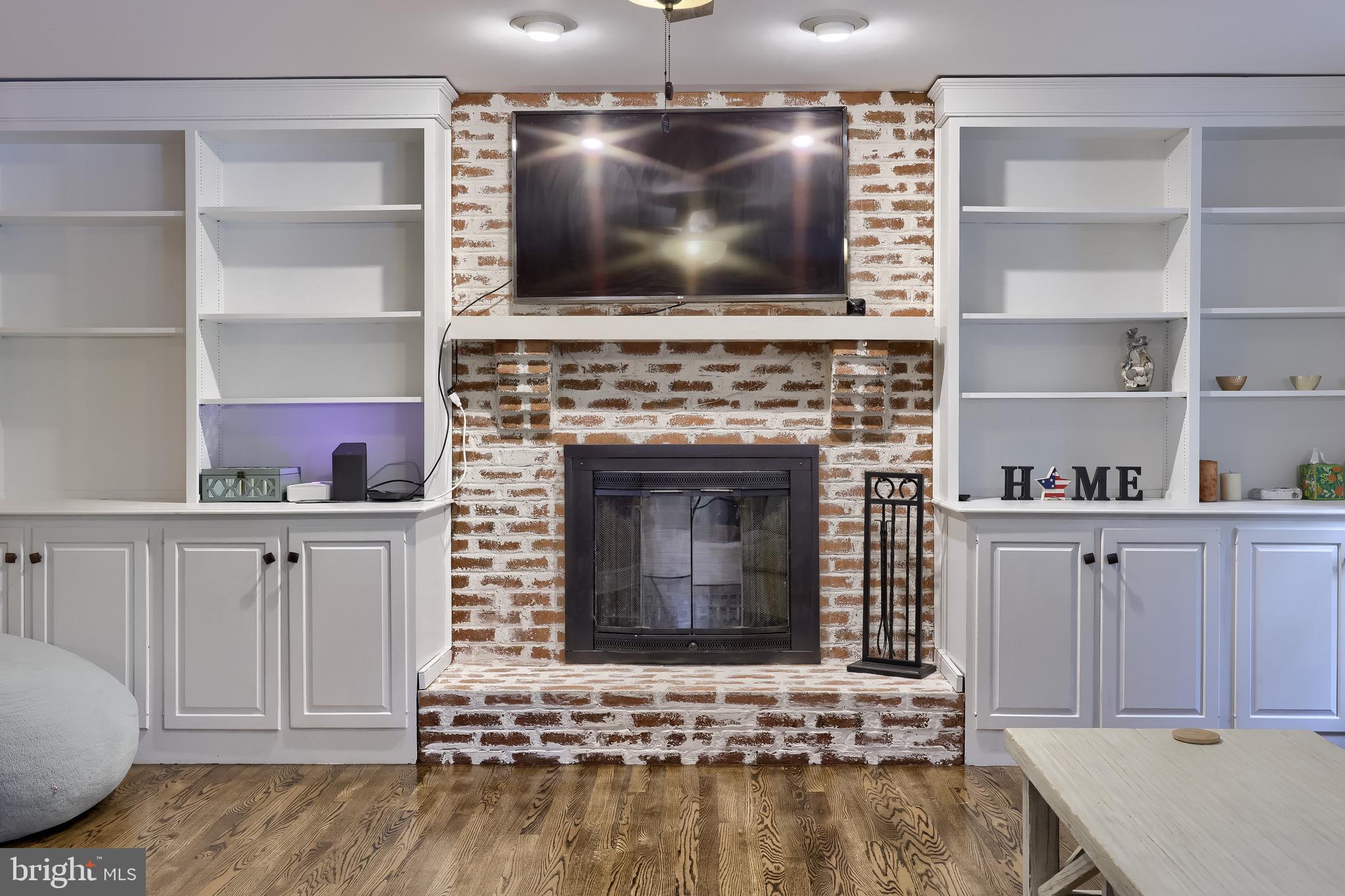 2504 Brookside Drive Lancaster, PA 17601 - Photo 26 of 53 a living room with a fireplace and a flat screen tv