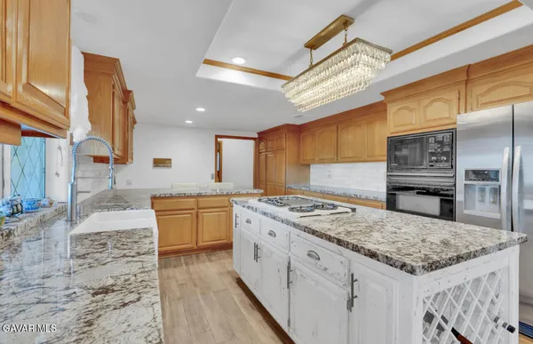 a kitchen with a stove a sink and a refrigerator