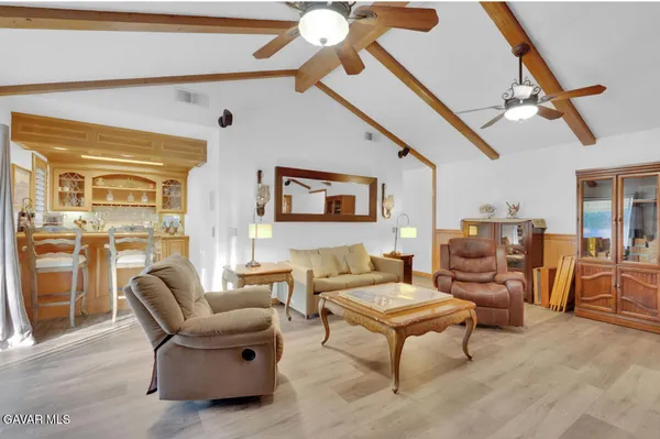 a living room with furniture and a ceiling fan