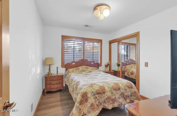 a bed sitting in a bedroom next to a window