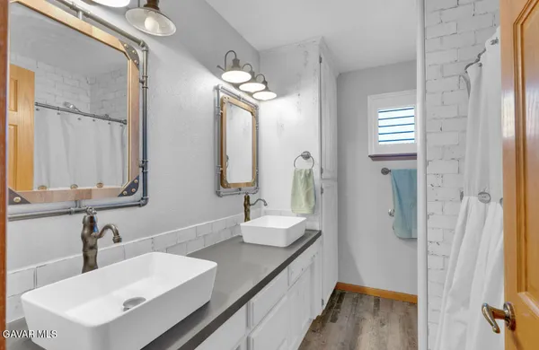 a bathroom with a sink double vanity and a mirror