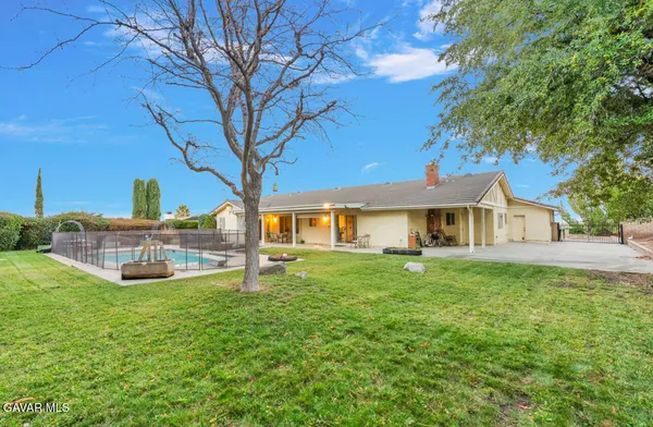 a view of a house with a yard porch and sitting area
