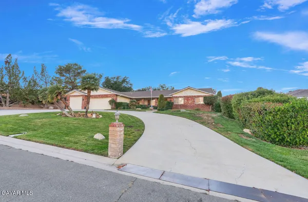 a view of a street with a houses in the background