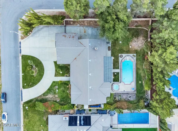 an aerial view of a house with a swimming pool
