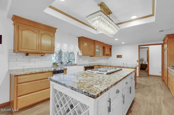 a kitchen with stainless steel appliances granite countertop a sink stove and cabinets