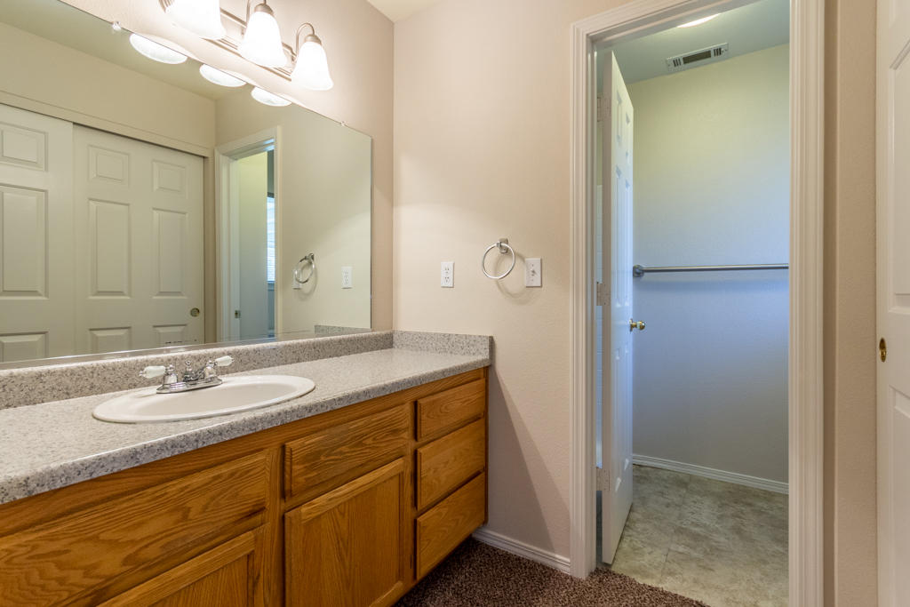 11380 Puffin Way Redding, CA 96003 - Photo 12 of 27 a bathroom with a granite countertop sink a mirror and a shower
