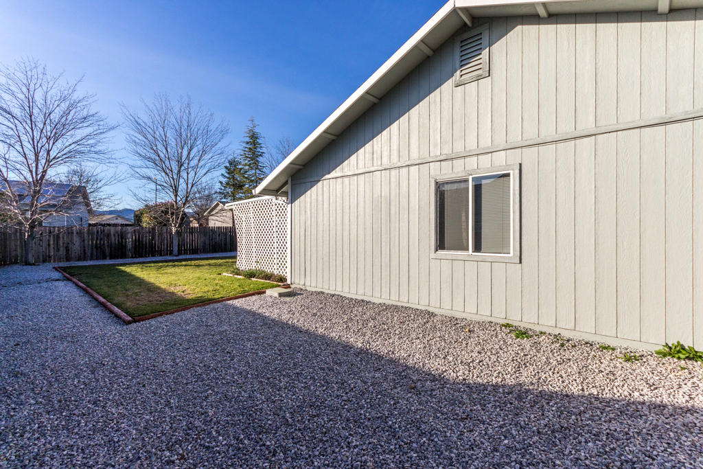 11380 Puffin Way Redding, CA 96003 - Photo 23 of 27 a view of a backyard with wooden fence