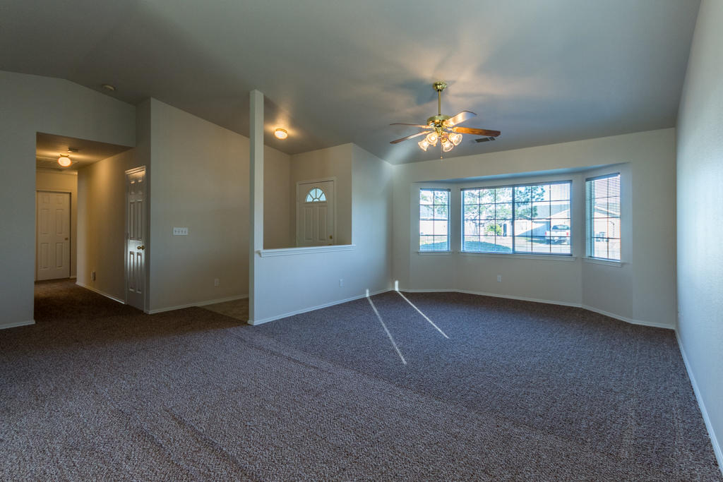 11380 Puffin Way Redding, CA 96003 - Photo 4 of 27 an empty room with chandelier fan and windows