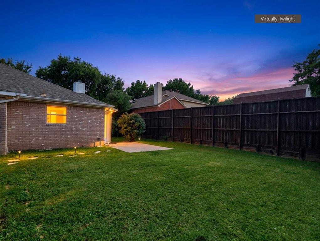 12000 Port Road Frisco, TX 75035 - Photo 36 of 40 Spacious backyard with a privacy fence, brick exterior, concrete patio, and ground lighting