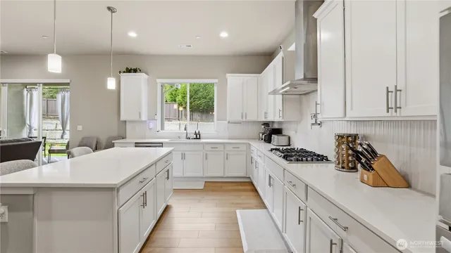 a kitchen with a sink a stove a refrigerator and cabinets