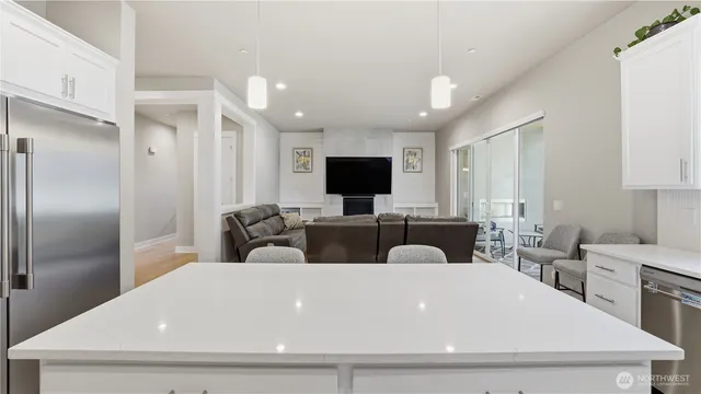 a large white kitchen with a large window