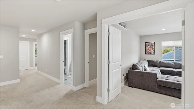 a living room with furniture and a view of hallway