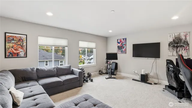 a living room with furniture a flat screen tv and a window