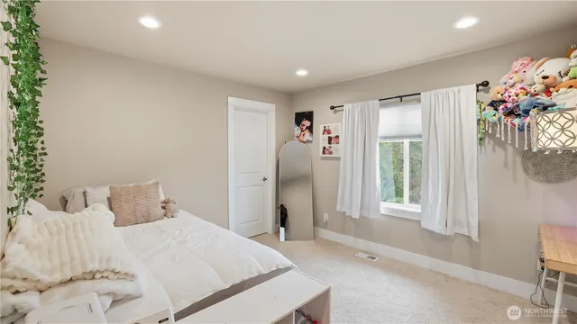 a spacious bedroom with a bed and a window