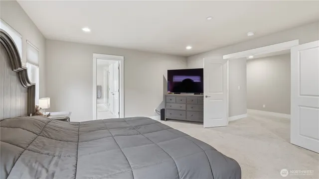 a bedroom with a bed and a flat screen tv