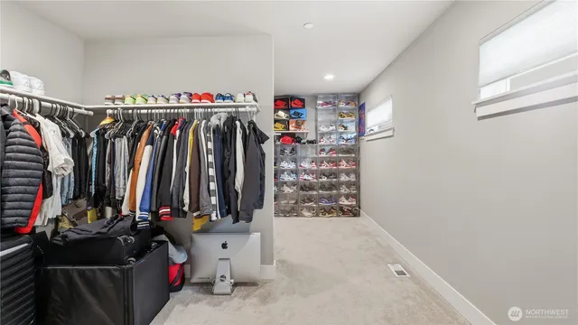 a view of walk in closet with clothes