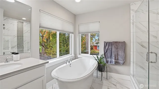 a bathroom with a granite countertop sink a toilet and shower