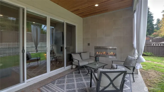a patio with yard glass top table and chairs