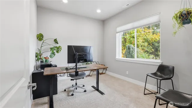 a view of a workspace with a window and sitting area