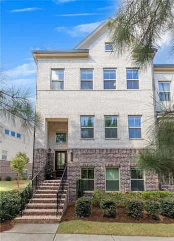 a front view of a house with yard and parking
