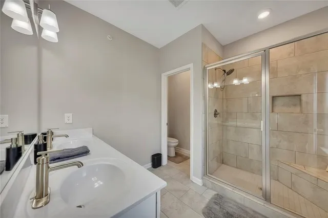 a bathroom with a double vanity sink a mirror and a shower