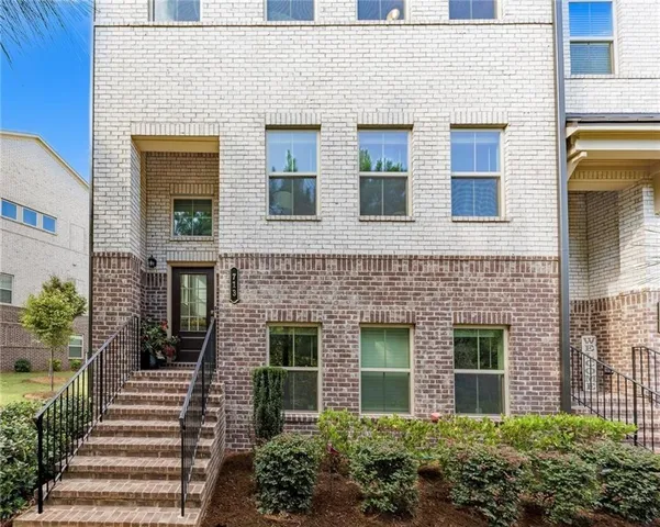 a view of a white building among the yard