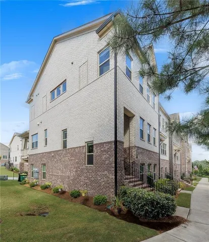 a view of a room that has a large window and front door