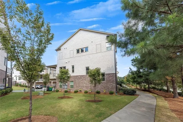 an aerial view of a house with outdoor space and a balcony