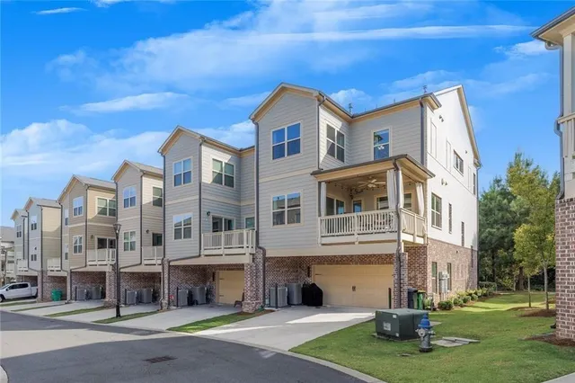 an aerial view of a house with a yard and potted plants