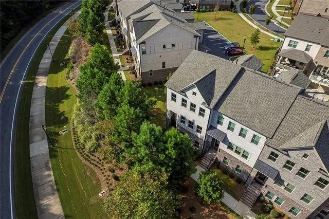 a view of a patio with table and chairs with barbeque grill and floor to ceiling window