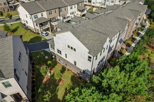 an aerial view of a house with a yard