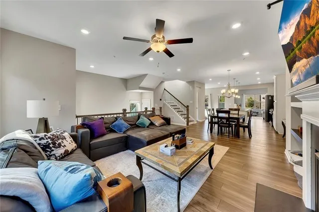 a view of a dining room with furniture a chandelier and wooden floor
