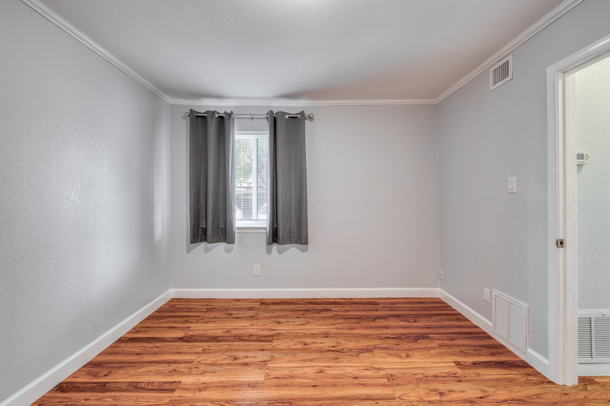 8210 Bent Tree Road, Unit 153 Austin, TX 78759 - Photo 17 of 20 Light gray walls with white crown molding and baseboards