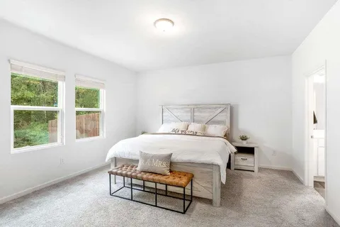 a bedroom with a bed and a window