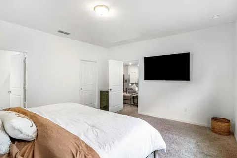 a bedroom with a bed and a flat screen tv
