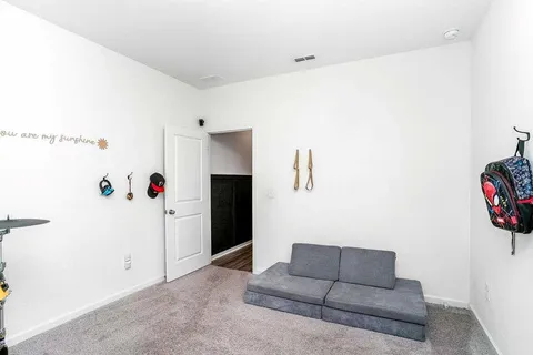 a living room with furniture and white walls
