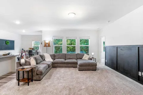 a living room with furniture and a large window