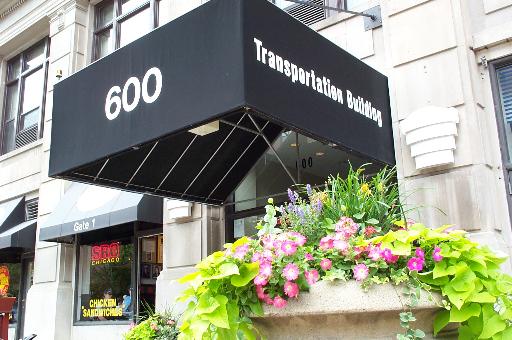 600 South Dearborn Street, Unit 902 Chicago, IL 60605 - Photo 1 of 1 a street sign that is in front of flowers