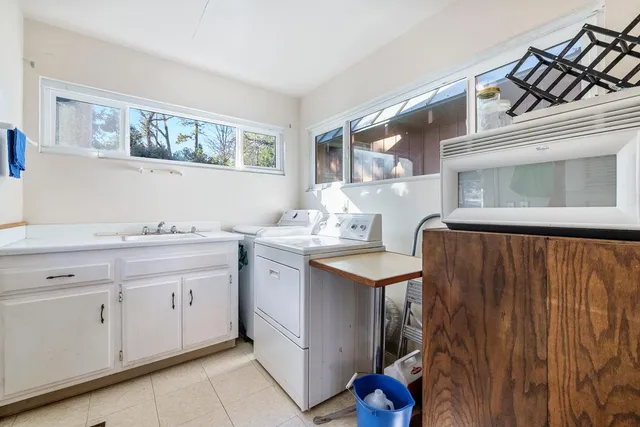 a spacious bathroom with a double vanity sink and a mirror