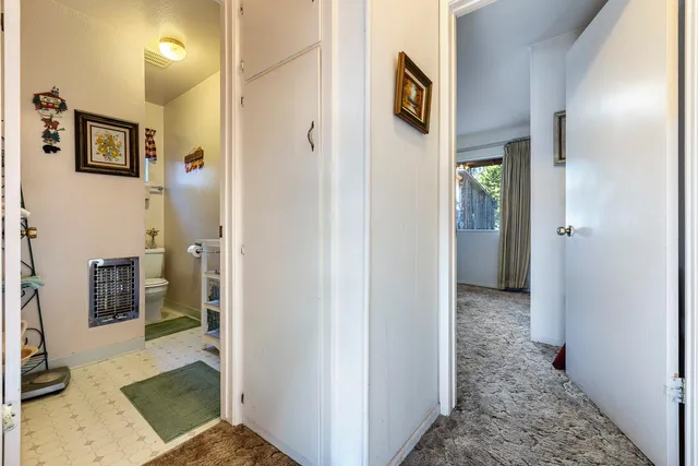 a view of a hallway with bathroom and shower