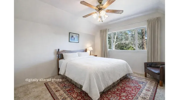 a bedroom with a large bed and a window